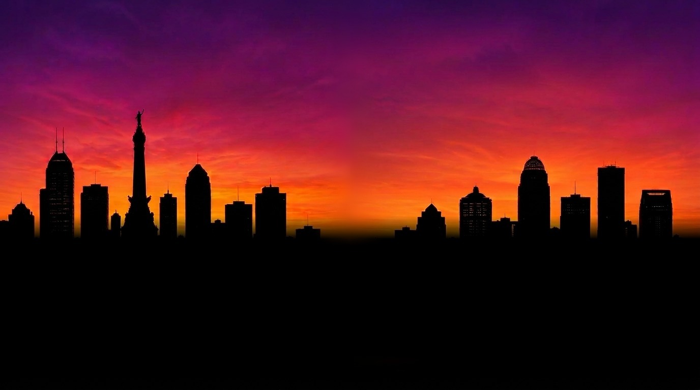 Illustrative composite of the Indianapolis and Louisville skylines at a vibrant pink and orange sunset, joined by a painted brush stroke